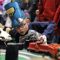 Peyton Langston, 7, of Springdale (above) operates an O-scale model train Saturday at the annual Gre...