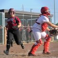 Madison Moore, Springdale High shortstop, crosses home plate as Farmington’s Kendra Center waits for...