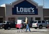 A customer pushes a shopping cart outside a Lowe’s store in East Peoria, Ill., on Wednesday. Lowe’s reported a fourth-quarter profi t Monday that beat analysts’ estimates. 