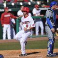Arkansas outfielder Tyler Spoon scores a run in the first game of a Feb. 19 doubleheader against New...