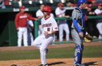 Arkansas outfielder Tyler Spoon scores a run in the first game of a Feb. 19 doubleheader against New Orleans at Baum Stadium in Fayetteville.