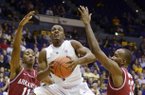 LSU's Anthony Hickey (1) splits Arkansas defenders B.J. Young (11) and Marshawn Powell (33) for a shot during an NCAA basketball game, Wednesday, Feb. 27, 2013, in Baton Rouge, La. LSU won 65-60. (AP Photo/The Advocate, Heather McClelland)