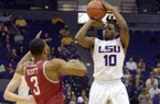 LSU's Andre Stringer (10) shoots a 3-pointer against Arkansas' Rickey Scott (3) during their NCAA college basketball game, Wednesday, Feb. 27, 2013, in Baton Rouge, La. (AP Photo/The Advocate, Heather McClelland)