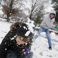 Michael Hickman of Bella Vista enjoys a friendly snowball fight Tuesday with his daughter Courtney, ...