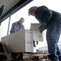 Carl Martin, right, and Harold Foreman, both volunteers with First United Methodist Church, unload a...