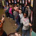 Nikki Hollard, left, director of the Razorback Writers Project, takes a photo Tuesday of Damara Hale...