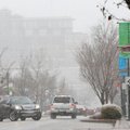 Snow continued to fall Tuesday on Dickson Street in Fayetteville. 