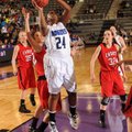 Taylor Strickland, center, a Rogers senior forward, takes a shot in the lane through the Cabot defen...