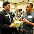 Raul Najera, right, of Springdale talks Wednesday to Geovanny Sarmiento, a NorthWest Arkansas Commun...