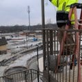 Alfredo Gonzales of Rogers works on wiring Wednesday atop one of the water slide towers at the Roger...