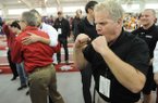 Arkansas men's track and field coach Chris Bucknam celebrates after winning the conference title Sunday, Feb. 24, 2013, during the Southeastern Conference Indoor Track and Field Championships at the Randal Tyson Track Center in Fayetteville.