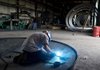 A welder works on oil tank tops  Westerman Companies Inc., a company that manufactures oil tanks for the fracking industry in Bremen, Ohio, U.S. on Tuesday, Sept. 4, 2012. A boom in oil production from the shale formations of North Dakota and Texas has the U.S. on a course to cut its reliance on imported crude oil to about 42 percent this year, the lowest level in two decades. Photographer: Ty Wright/Bloomberg