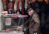 A customer inspects a cut of meat at a butcher shop in Genzano, Italy, on Friday. Eurozone unemployment rose to 11.9 percent in January, up from 11.8 percent in December. 