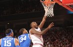 Arkansas junior forward Marshawn Powell dunks the ball past Kentucky guard Julius Mays (34) during the first half of play Saturday, March 2, 2013, in Bud Walton Arena in Fayetteville.