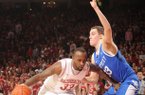 Arkansas junior forward Marshawn Powell, left, drives into the lane as Kentucky sophomore forward Kyle Wiltjer defends Saturday, March 2, 2013, in Bud Walton Arena in Fayetteville.