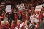 Arkansas fans hold signs directed at Little Rock native and Kentucky freshman guard Archie Goodwin during the first half of play Saturday, March 2, 2013, in Bud Walton Arena in Fayetteville.