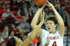 Arkansas forward Sarah Watkins pulls up for a jump shot over Ole Miss defender Monique Jackson Sunday at Bud Walton Arena in Fayetteville.