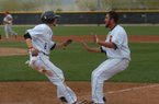 Pacific's Brett Sullivan is greeted at home plate by a teammate after scoring the game-winning run in the bottom of the ninth inning Sunday in Surprise, Ariz. 