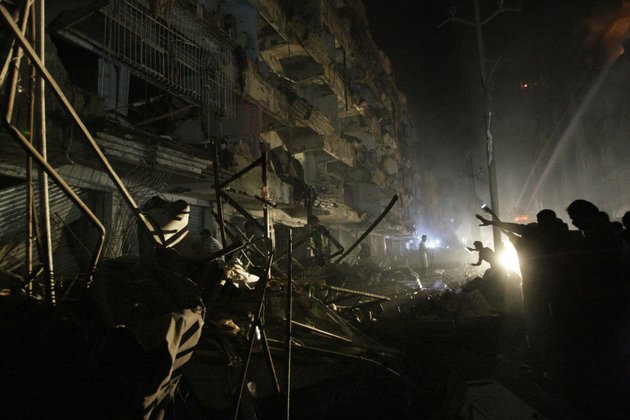 pakistanis-check-the-site-of-a-bomb-blast-in-karachi-pakistan-sunday-march-3-2013-pakistani-officials-say-a-bomb-blast-has-killed-dozens-of-people-in-a-neighborhood-dominated-by-shiite-muslims-in-the-southern-city-of-karachi