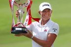 Stacy Lewis of the United States poses with the challenge trophy after winning the HSBC Women's Champions golf tournament on Sunday, March 3, 2013 in Singapore. (AP Photo/Wong Maye-E)