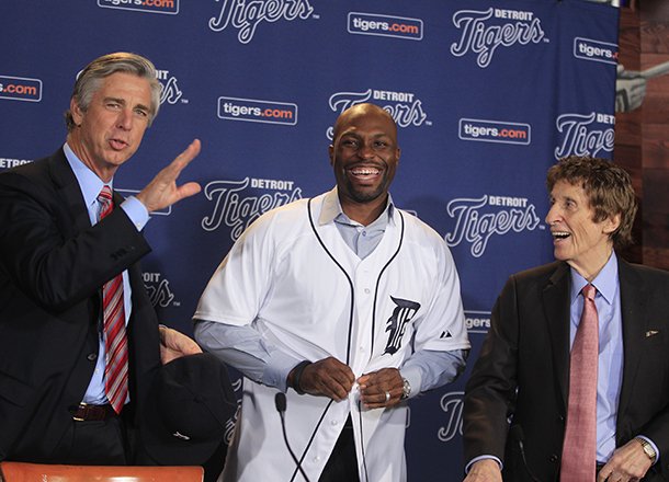 detroit-tigers-outfielder-torii-hunter-smiles-after-putting-on-his-jersey-as-team-general-manager-david-dombrowski-left-and-owner-mike-ilitch-look-on-before-a-news-conference-in-detroit-friday-nov-16-2012-hunter-who-last-played-for-the-los-angeles-angels-signed-a-two-year-26-million-deal-ap-photocarlos-osorio