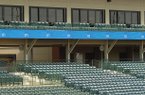 Stadium workers test new LED ribbon boards Monday at Baum Stadium in Fayetteville.