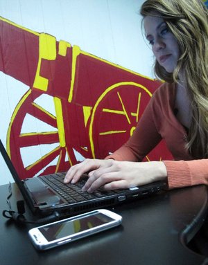 With her cell phone nearby, Mahrinah von Schlegel, managing director of Cibola, an incubator for tech entrepreneurs that will open this spring, checks a social-networking site at her office in Chicago. 