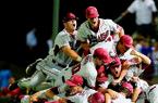 Arkansas players pile on after the Razorbacks beat Baylor 1-0 in Monday’s elimination game in the Waco (Texas) Super Regional. Razorbacks reliever Colby Suggs, who earned the victory, and four other pitchers held Baylor scoreless on five hits. With the victory, Arkansas advances to the College World Series for the seventh time, opening their trip with a game against Kent State on Saturday. 