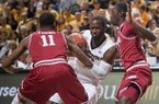 Missouri's Keion Bell, center, drives between Arkansas' BJ Young, left, and Fred Gulley, right, during the first half of an NCAA college basketball game Tuesday, March 5, 2013, in Columbia, Mo. (AP Photo/L.G. Patterson)