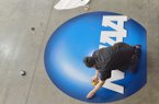  Robbie Hanner with The Sign Factory in Fayetteville, works on preparing an NCAA sign to hang up at the Tyson Indoor Track Facility Wednesday afternoon. Arkansas will be hosting the 2013 NCAA Track and Field championships that will be held Friday March 8 and Saturday March 9th.