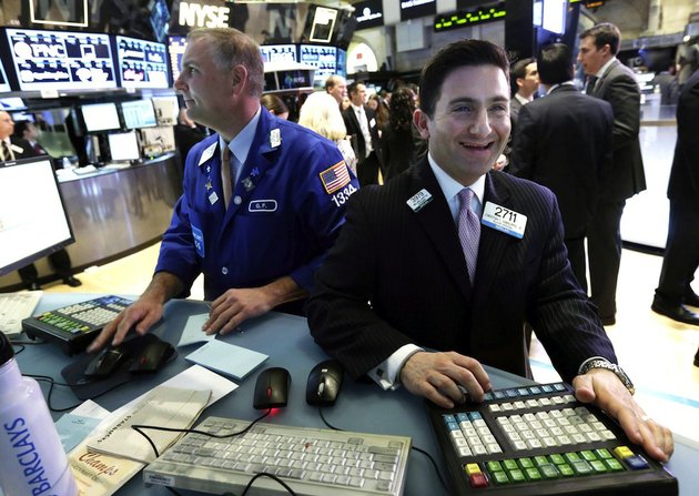 file-in-this-tuesday-march-5-2013-file-photo-specialist-christian-sanfillippo-right-smiles-as-he-works-at-his-post-on-the-floor-of-the-new-york-stock-exchange-the-dows-new-all-time-high-and-better-economic-data-from-the-united-states-propelled-world-stock-markets-higher-wednesday-march-6-2013