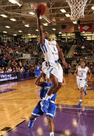 
North Little Rock senior guard Gary Vines (2) scores in transition as Bryant junior guard CJ Rainey trails the play Friday, March 1, 2013, during the first half of play in the Class 7A State Basketball Tournament at Fayetteville High School.