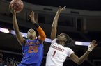 Florida forward Christin Mercer (25) drives to the basket as Arkansas forward Keira Peak (1) defends during the first half of an NCAA college basketball game at the Southeastern Conference tournament, on Thursday, March 7, 2013, in Duluth, Ga. (AP Photo/John Bazemore)