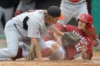 Arkansas outfielder Joe Serrano avoids the tag of San Diego State pitcher Philip Walby as he scores a run in the third inning to tie up the score 2-2 during Friday night's baseball game at Baum Stadium in Fayetteville.
