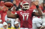 Arkansas quarterback Brandon Mitchell pulls up to pass in a 2012 game against Alabama at Razorback Stadium in Fayetteville.