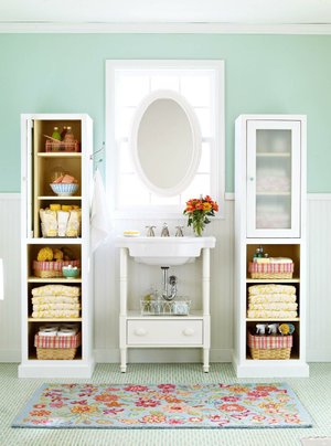 Repeating a good idea is a smart move in a bathroom short on space. Flank a pedestal sink with identical storage towers. For a family bathroom, designate a section of the cabinets to each family member. 