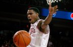 Arkansas junior Coty Clarke celebrates after dunking against Texas A&M during the second half on Saturday, March 9, 2013, at Bud Walton Arena.