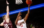 Arkansas junior BJ Young (right) drives to the basket against Texas A&M senior Jarod Jahns during the first half on Saturday, March 9, 2013, at Bud Walton Arena in Fayetteville.