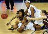 Middle Tennessee guard Kortni Jones (bottom left) and teammate Ebony Rowe (top right) battle for a loose ball with UALR’s Taylor Gault (top) and Hannah Fohne (right) during the fi nal minute of Monday’s Sun Belt Conference women’s basketball fi nal at Summit Arena in Hot Springs. UALR lost 53-48 to the Blue Raiders. 