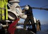 Dietz Brothers Inc. towermen attach the blades of a Polaris America LLC wind turbine installed by Renewable Energy SD in Elgin, Minn., in February 2012. 