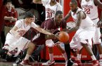 Arkansas juniors Kikko Haydar (left) and Marshawn Powell pressure Texas A&M senior Ray Turner during the first half on Saturday, March 9, 2013, at Bud Walton Arena in Fayetteville.