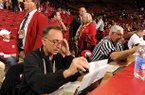 Longtime Arkansas public address announcer John George of Springdale reads pregame announcements Saturday, Feb. 16, 2013, before the start of the Hogs' game with Missouri in Bud Walton Arena in Fayetteville. George will be working the SEC Tournament for the sixth consecutive year. 