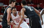 Arkansas' Rashad Madden, center, keeps close to Kedren Johnson of Vanderbilt Saturday, Jan. 12, 2013, during the first half of the first home conference game at Bud Walton Arena in Fayetteville.