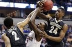 Arkansas guard Mardracus Wade (1) vies for a loose ball with Vanderbilt's Dai-Jon Parker (24) and Kedren Johnson (2) during the first half of an NCAA college basketball game at the Southeastern Conference tournament, Thursday, March 14, 2013, in Nashville, Tenn. (AP Photo/John Bazemore)