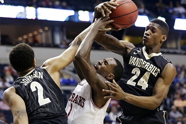 Arkansas guard Mardracus Wade (1) vies for a loose ball with Vanderbilt's Dai-Jon Parker (24) and Kedren Johnson (2) during the first half of an NCAA college basketball game at the Southeastern Conference tournament, Thursday, March 14, 2013, in Nashville, Tenn. (AP Photo/John Bazemore)