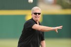 Arkansas track and field coach Chris Bucknam throws out the first pitch Friday, March 15, 2013, before the start of play at Baum Stadium in Fayetteville in recognition of his indoor squad's SEC and NCAA titles.