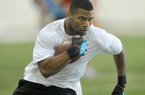 Running back Knile Davis runs drills for NFL scouts Friday afternoon at Walker Pavilion during Pro Day at the University of Arkansas in Fayetteville.