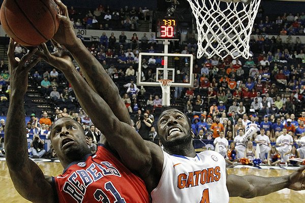Florida center Patric Young (4) vies for a rebound with Mississippi forward Murphy Holloway (31) during the first half of an NCAA college basketball game in the final round of the Southeastern Conference tournament, Sunday, March 17, 2013, in Nashville, Tenn. (AP Photo/John Bazemore)
