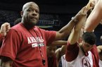 Arkansas basketball coach Mike Anderson joins his team in a prayer after a practice in Nashville on Wednesday as they prepare for the SEC Tournament.