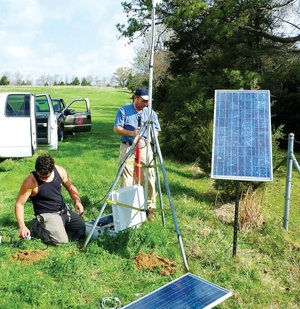 From the left, David Steiner with the Center for Earthquake Research and Information at the University of Memphis and Scott Ausbrooks, a geologist with the Arkansas Geological Survey, work on a temporary seismic monitoring station southeast of Greenbrier in March 2011. The station that will be installed in the Greers Ferry area will be similar to the one pictured. 